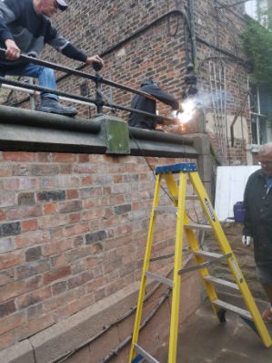 team rebuilding a wall